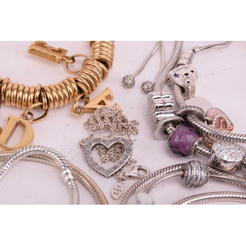 128 - A collection of branded jewellery comprising ten Pandora bangles some with charms, a Thomas Sabo sna... 