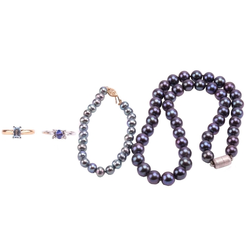 130 - Two gem set rings, a Tahitian pearl necklace and a bracelet. Featuring A sapphire and diamond dress ... 