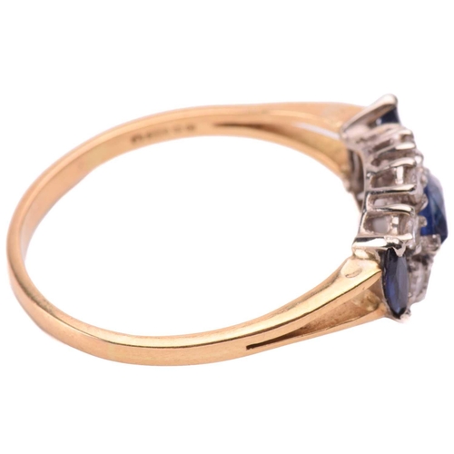 136 - A sapphire and diamond cluster ring in 18ct yellow gold, centred with a marquise-cut sapphire surrou... 