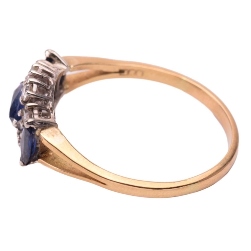 136 - A sapphire and diamond cluster ring in 18ct yellow gold, centred with a marquise-cut sapphire surrou... 