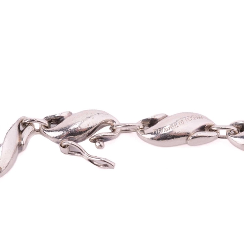 14 - Tiffany & Co. - a seahorse link bracelet by Elsa Peretti, comprising thirteen S-shaped links, secure... 