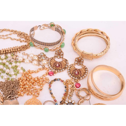 146 - A quantity of base metal costume jewellery including Indian Wedding suites, bangles with some hinged... 