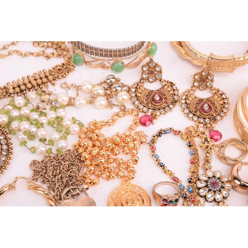 146 - A quantity of base metal costume jewellery including Indian Wedding suites, bangles with some hinged... 