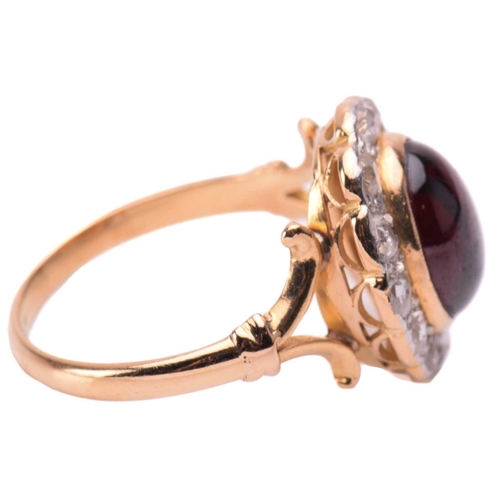 155 - A garnet and rose diamond cluster ring, centred with an oval garnet hollow cabochon in a millgraine ... 