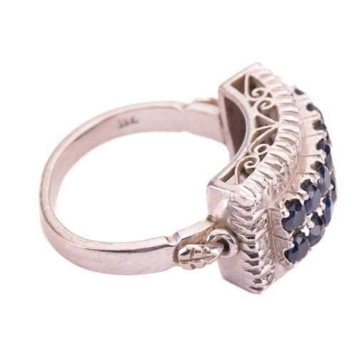 157 - A sapphire and diamond four-row half hoop ring, set with two rows of circular-cut sapphires with an ... 