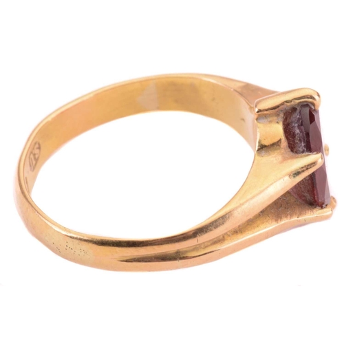 165 - A garnet single stone ring, the almandine garnet measuring 10 x 7.9mm, in a claw setting, the shank ... 