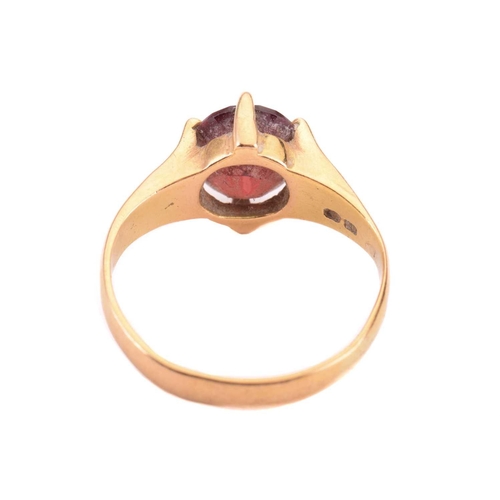 165 - A garnet single stone ring, the almandine garnet measuring 10 x 7.9mm, in a claw setting, the shank ... 