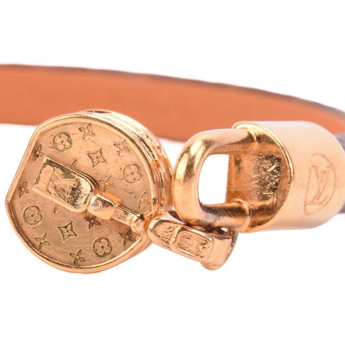 181 - Louis Vuitton - a 'Tribute' bracelet, comprising a monogram canvas strap with leather lining, dangli... 