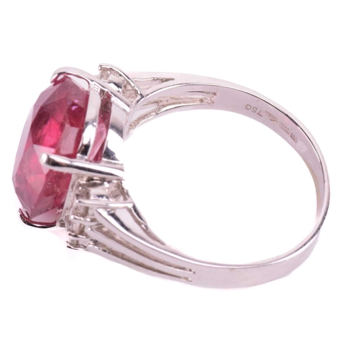 183 - A ruby and diamond ring, the four-claw set oval cut ruby approximately 12.5mm x 11.5mm, the trifurca... 