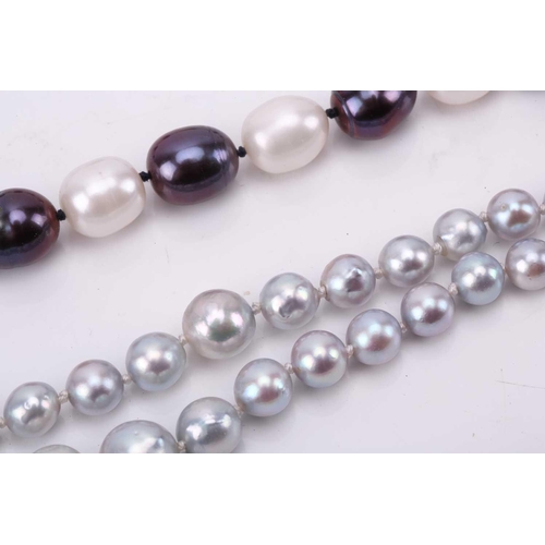 187 - A double strand of slightly graduated pale grey cultured pearls, with a silver and metal clasp, Pear... 