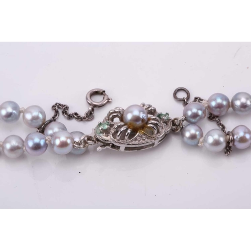 187 - A double strand of slightly graduated pale grey cultured pearls, with a silver and metal clasp, Pear... 