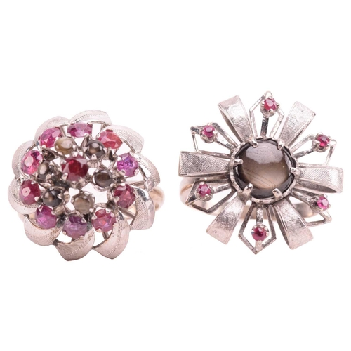 189 - Two floral cocktail rings set with ruby and black star sapphire; the first centred with a round blac... 