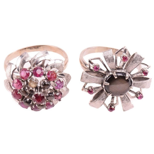 189 - Two floral cocktail rings set with ruby and black star sapphire; the first centred with a round blac... 