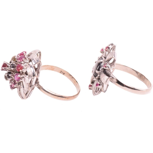 189 - Two floral cocktail rings set with ruby and black star sapphire; the first centred with a round blac... 