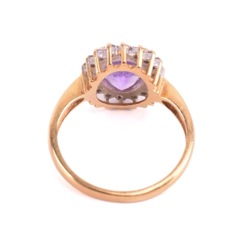 193 - An amethyst and diamond cluster ring, set with a central amethyst measuring 8.9 x 7 x 5mm, encircled... 