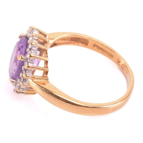 193 - An amethyst and diamond cluster ring, set with a central amethyst measuring 8.9 x 7 x 5mm, encircled... 