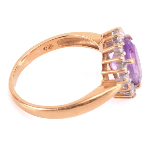 193 - An amethyst and diamond cluster ring, set with a central amethyst measuring 8.9 x 7 x 5mm, encircled... 