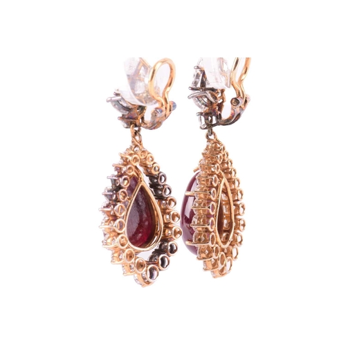 199 - A pair of ruby and diamond pendant earrings, each set with a large pear-shaped diamond, with an esti... 