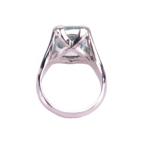 201 - A single stone aquamarine dress ring, the mixed rectangular cut aquamarine, with double claw mounts,... 