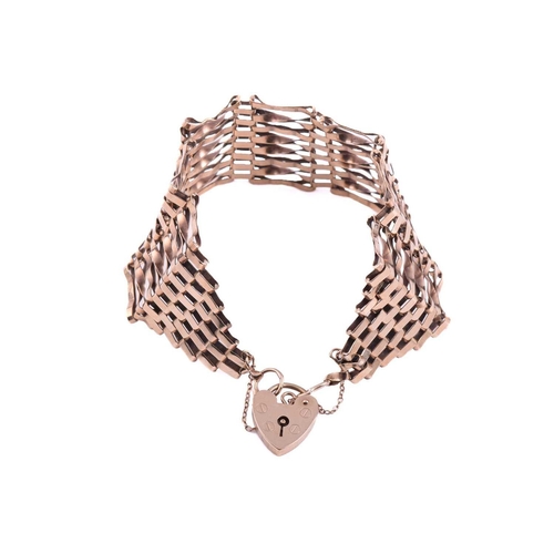 209 - A gate bracelet, formed of a wide mesh of plain and twisted links, measuring 26mm wide with a length... 