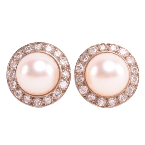 217 - A pair of cultured pearl and diamond halo earrings, the central pearls approximately 8.64 mm in diam... 