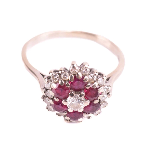 220 - A ruby and diamond cluster ring, set with rubies and round brilliant cut diamonds with a total estim... 