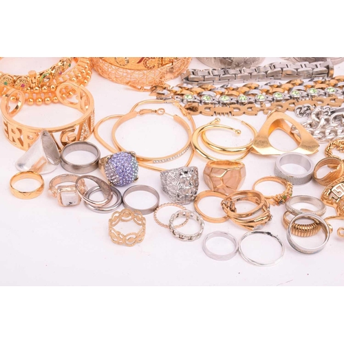 231 - A quantity of base metal costume jewellery comprising a collection of bangles including hinged examp... 