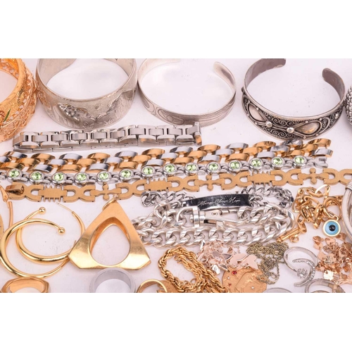 231 - A quantity of base metal costume jewellery comprising a collection of bangles including hinged examp... 