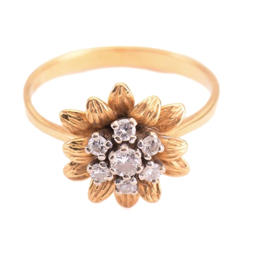 234 - A diamond flower ring, set with a central cluster of round brilliant cut diamonds with a total estim... 