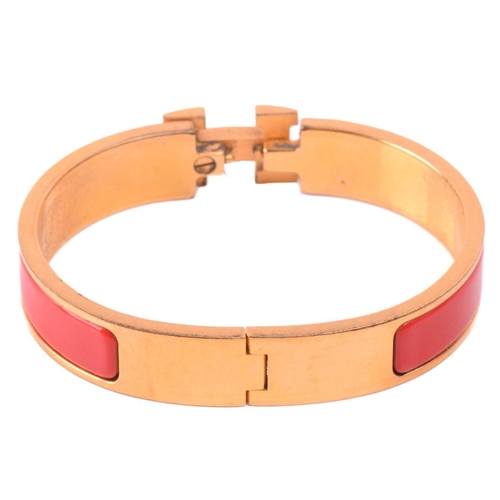 262 - Hermès - a narrow 'Clic H' bracelet with red enamel and gold-tone metal, signed and marked, internal... 