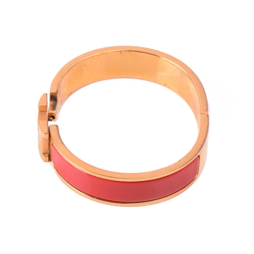 262 - Hermès - a narrow 'Clic H' bracelet with red enamel and gold-tone metal, signed and marked, internal... 