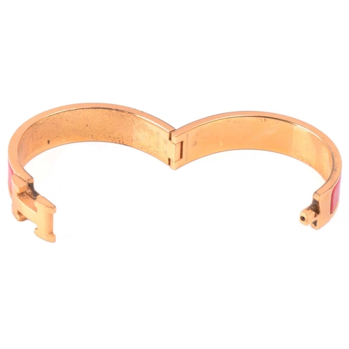 262 - Hermès - a narrow 'Clic H' bracelet with red enamel and gold-tone metal, signed and marked, internal... 