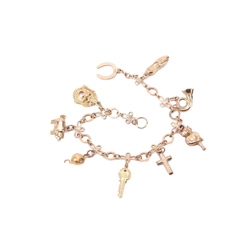 274 - A charm bracelet with various charms, some with hallmarks for 9ct gold, the bracelet measuring 18cm ... 