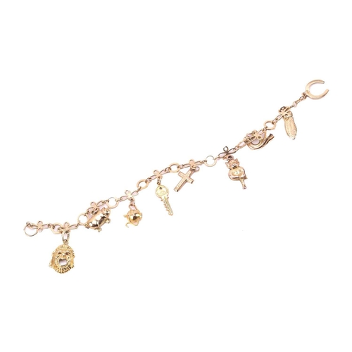 274 - A charm bracelet with various charms, some with hallmarks for 9ct gold, the bracelet measuring 18cm ... 