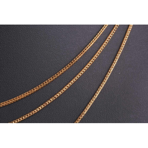 300 - A three-strand chain necklace, the foxtail link chains graduating in length from 62cm to 68cm, with ... 