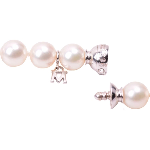 302 - Mikimoto. A slightly graduated cultured pearl necklace to an 18-carat white gold and diamond ball cl... 