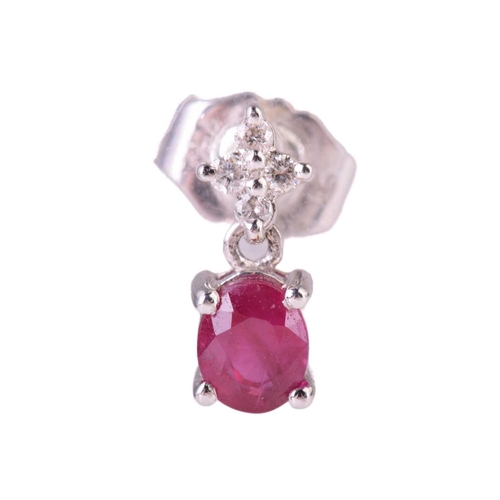 303 - A ruby and diamond cluster pendant, the central ruby measuring 5.7 x 5.2mm, encircled by round brill... 