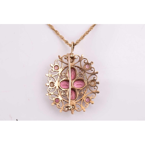 315 - A tourmaline and seed pearl pendant/brooch with a scrolling filigree mount, measuring 34mm x 30mm, w... 