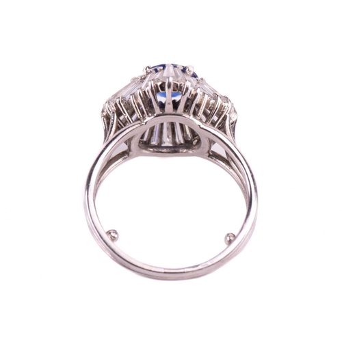 270 - A sapphire and diamond dress ring, centred with a circular-cut sapphire of bright blue colour, appro... 