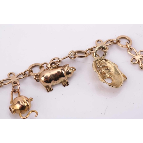 274 - A charm bracelet with various charms, some with hallmarks for 9ct gold, the bracelet measuring 18cm ... 