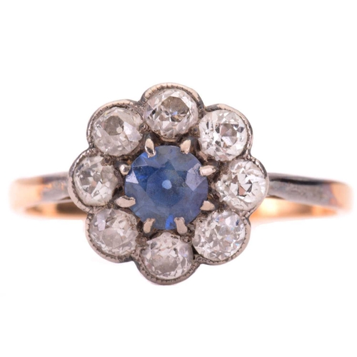 285 - A sapphire and diamond cluster ring, the central sapphire measuring 4.7mm diameter, encircled by old... 