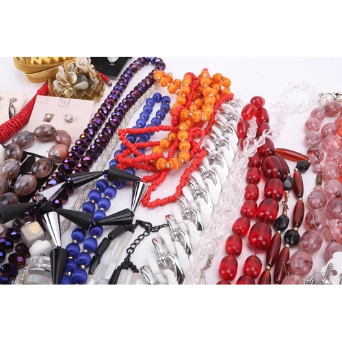 30 - A large quantity of costume jewellery including six sleeve garters, various buttons, beaded necklace... 