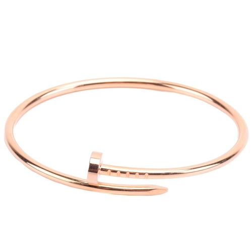 301 - Cartier - a 'Juste un Clou' bracelet in 18ct yellow gold, small model, of a bent nail motif, signed ... 