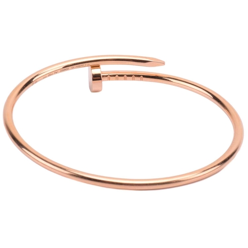 301 - Cartier - a 'Juste un Clou' bracelet in 18ct yellow gold, small model, of a bent nail motif, signed ... 