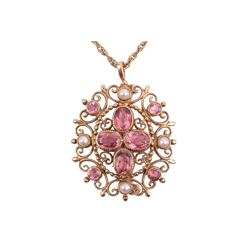 315 - A tourmaline and seed pearl pendant/brooch with a scrolling filigree mount, measuring 34mm x 30mm, w... 