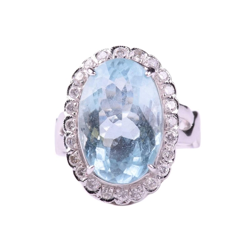 318 - An aquamarine and diamond cluster ring, set with an aquamarine measuring 16.2mm x 10.8mm, encircled ... 