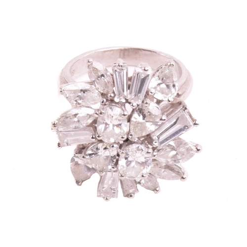 319 - A diamond cluster ring, set with an array of oval, marquise, pear shape, and tapered baguette cut di... 