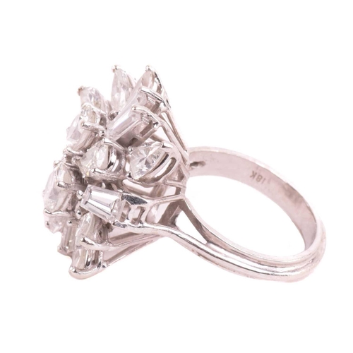 319 - A diamond cluster ring, set with an array of oval, marquise, pear shape, and tapered baguette cut di... 