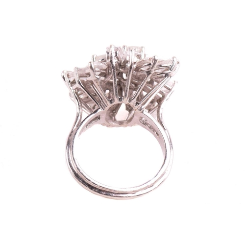 319 - A diamond cluster ring, set with an array of oval, marquise, pear shape, and tapered baguette cut di... 