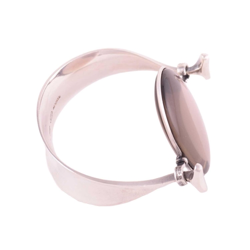 327 - Georg Jensen - 'Arm Ring' with smokey quartz, a tension clamp opening bangle with an oval panel of p... 